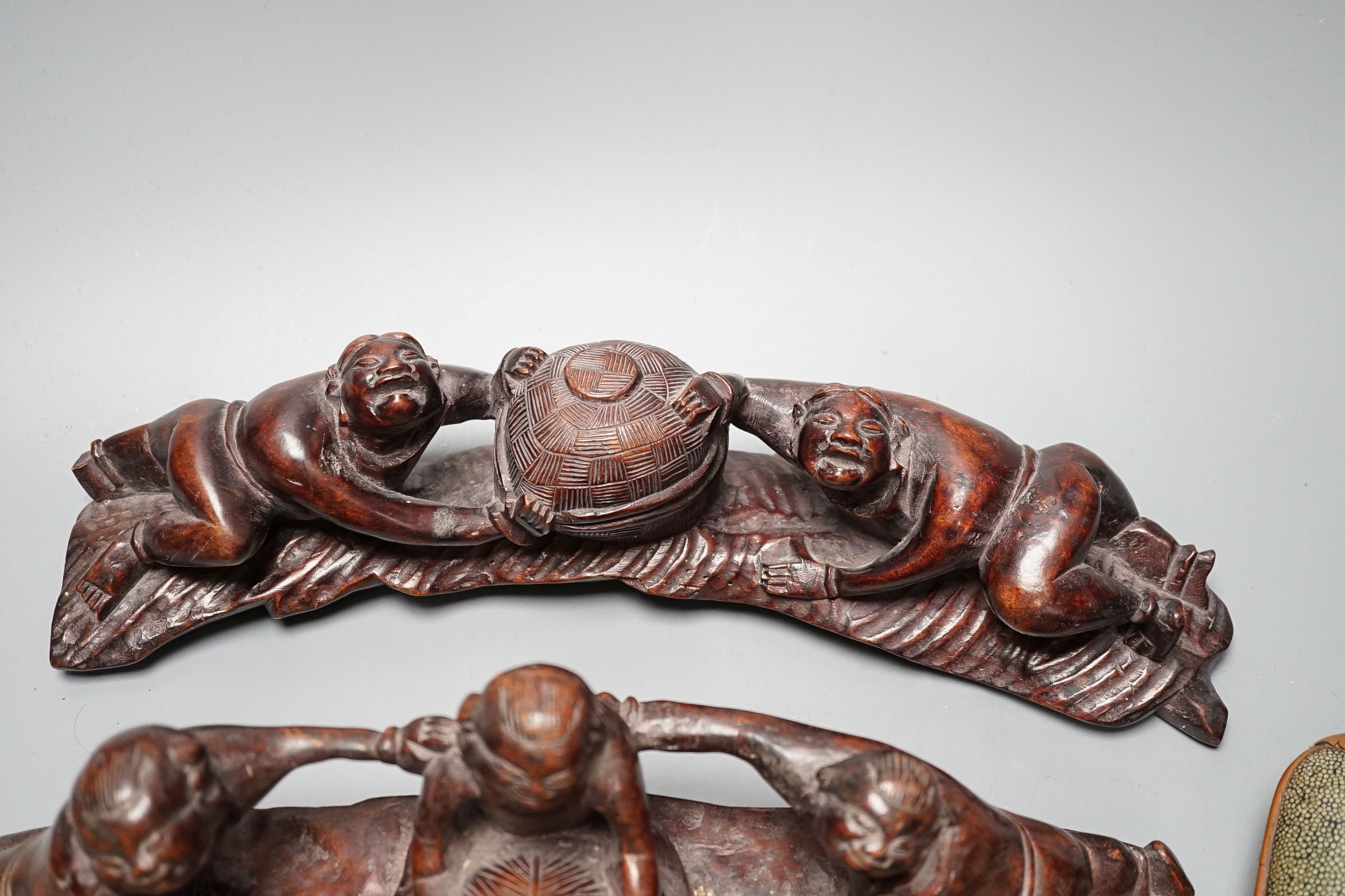 Two Chinese Qing spectacle cases, 19cm, and three hardwood carvings of boys